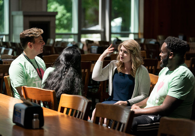 Associate Director of Residential Colleges Natalee Erb (second from right) speaks with VUceptors at The Commons Dining Center. (Joe Howell/Vanderbilt)