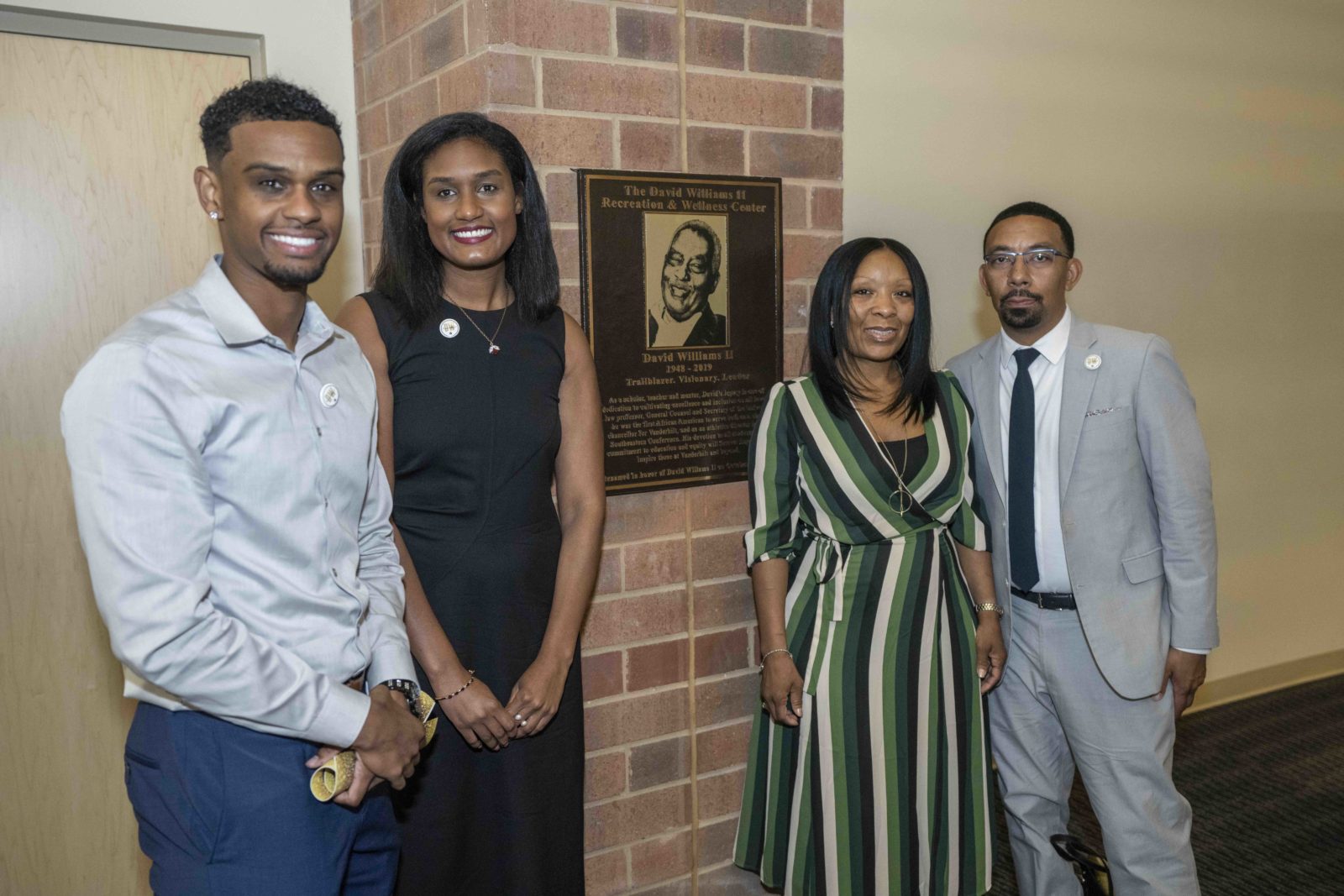 David Williams' children stand next to a new plaque honoring Vanderbilt's late former athletics director and vice chancellor. (John Russell/Vanderbilt University)