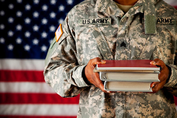 Military person holding books