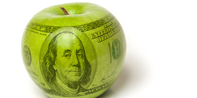 Green apple with a $100 bill superimposed over it to symbolize the cost of education
