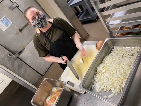 Campus Dining staff member prepares food in kitchen