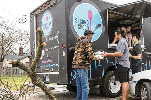 photo of students distributing meals from a food truck