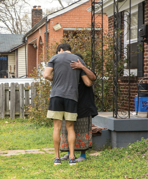 photo of a student hugging a woman whose neighborhood has been damaged by tornadoes