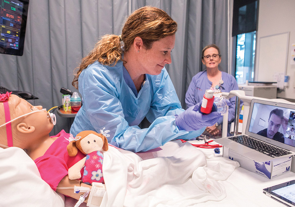 photo of an instructor collaborating with a student remotely on how to provide care to a nursing mannequin