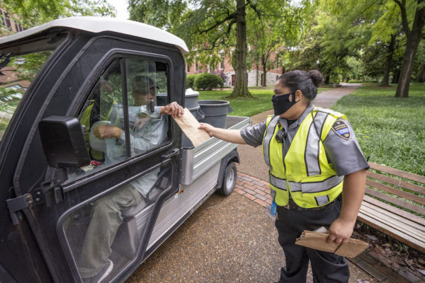 COVID ambassador provides face mask to campus employee