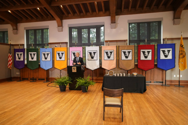 Chancellor Daniel Diermeier delivers first official faculty address to a virtual audience ore announcing awards displayed on table handing out faculty awards