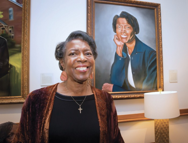 Dorothy Phillips poses beside her Trailblazer portrait