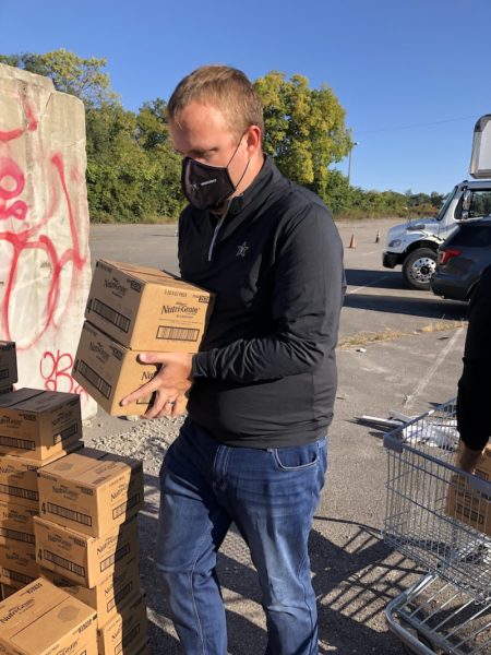 Daniel Culbreath, assistant vice chancellor for state government relations, assists with food distribution efforts during Saturday's event