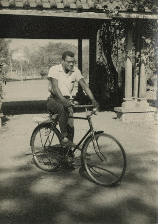 the Rev. James M. Lawson Jr. riding a bicycle in India during the 1950s