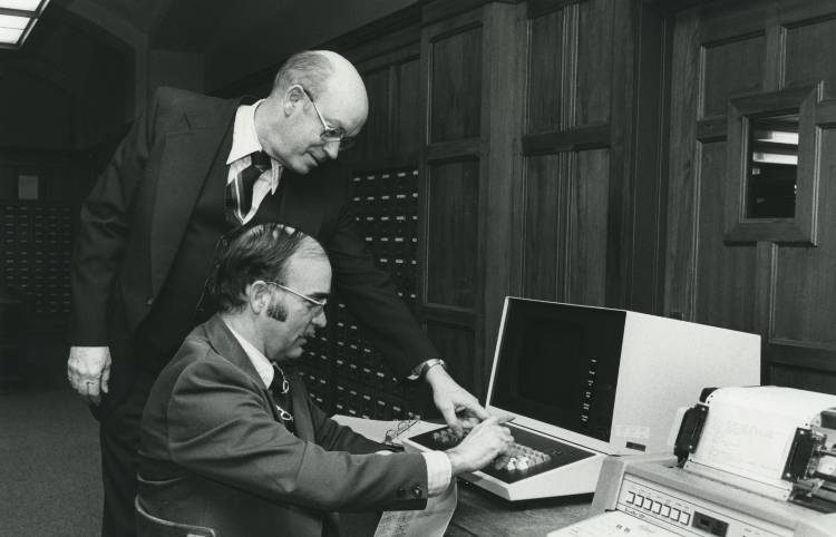 Frank Grisham (standing) demonstrates computer equipment at the Joint University Library. (Vanderbilt University Special Collections and Photo Archives)
