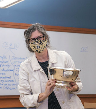 Engineering faculty member Lori Troxel holds engraved silver bowl that she will keep for a year