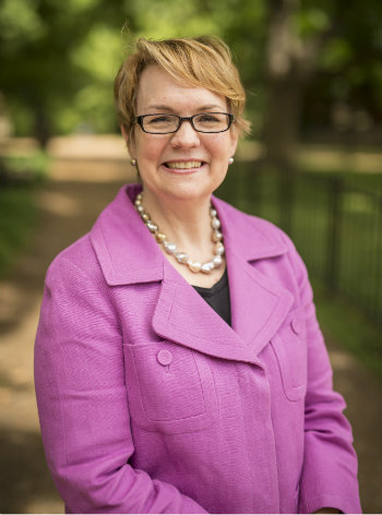 headshot of Vanessa Beasley outside wearing dark pink jacket