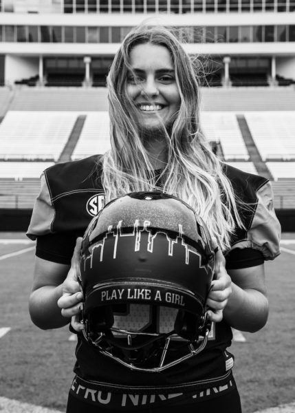 Student Sarah Fuller holds her football helmet