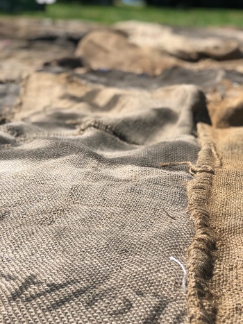 Jute sacks to be sewn together (courtesy of Engine for Art, Democracy and Justice)