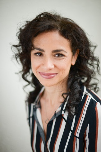 headshot of Emily Lordi in striped shirt