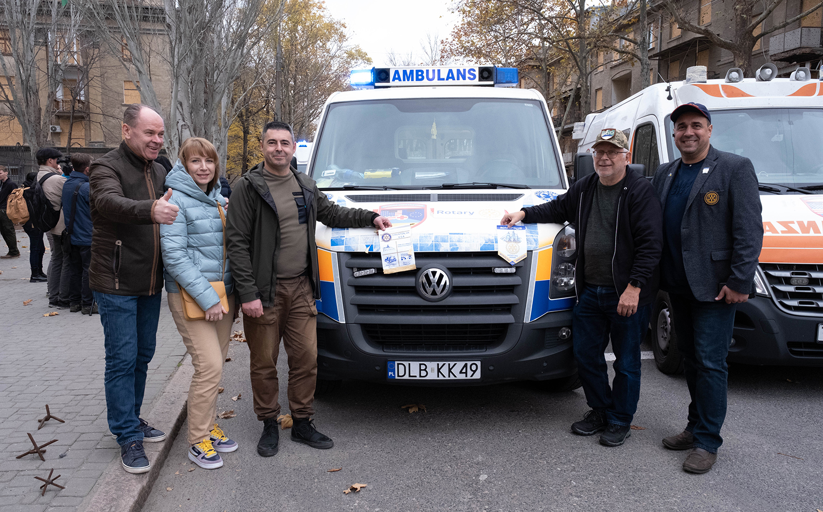 Numerous people from the Mykolaiv Oblast province of Ukraine as alumnus Michael Quillen delivers an ambulance to them.