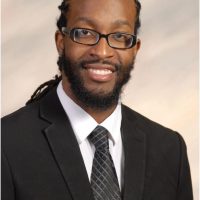 man in black suit and glasses