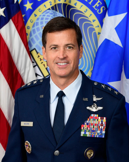 photograph of Lieutenant General Tuna Moore in military dress with flags in background