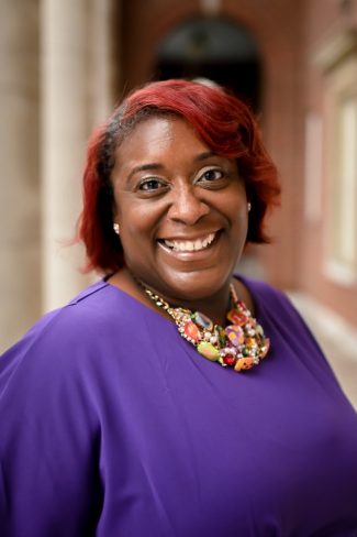 A photograph of Peabody College Professor Nicole M. Joseph on the front terrace of the Faye and Joe B. Wyatt Center