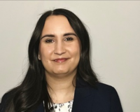 woman wearing blue suit and white blouse with flower prints