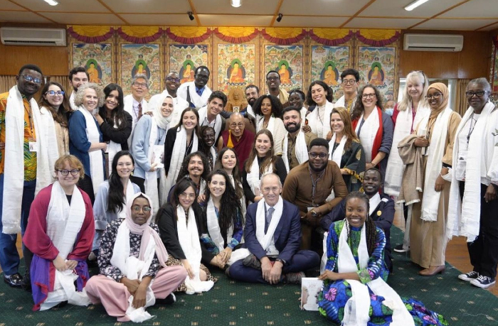 Alumona and other participants in the United States Institute of Peace Generation Change Program meet with the Dalai Lama in September.