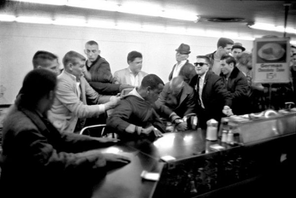 Several men attempt to drag a nonviolent student sit-in demonstrator from his stool at the lunch counter in the upstairs section of Woolworth’s on Fifth Avenue North. February 27, 1960. Photo by Vic Cooley. Nashville Banner Archives, Nashville Public Library, Special Collections