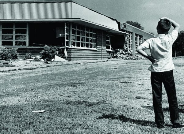 A perplexed little boy surveyed the damage done to Hattie Cotton School by dynamite. September 10, 1957. Photo by Bill Preston. Courtesy of The Tennessean
