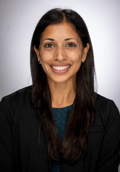 studio headshot of Mallika Vinekar with black jacket