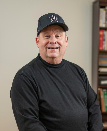 photograph of Christopher Johns in his office