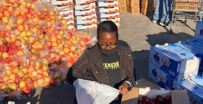 Volunteers prepare food packages. Vanderbilt University and OneGenAway, a nonprofit organization that strives to eliminate food deserts, partnered to provide 30,000 pounds of healthy food to families in the Midtown, Edgehill and Chestnut Hill neighborhoods in Oct. 2020.