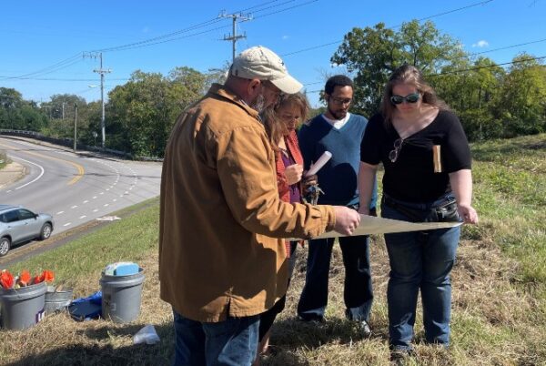 Photograph at Fort Negley of Andrew Wyatt, Jeneene Blackman, Sean Cardell and Angela Sutton looking at Sanborn map to compare plots with addresses listed in the 1900 census records for Bass Street