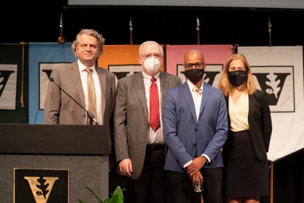 photograph of Daniel Diermeier, Mark Magnuson, award recipient Brandon Byrd and Provost Cybele Raver