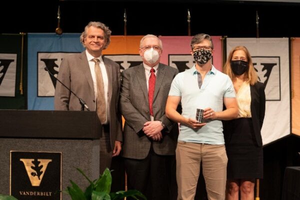 photograph of award winner Andrew Coe with Daniel Diermeier, Mark Magnuson and Cybele Raver