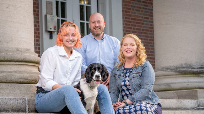 Peabody professor Emily Pendergrass with her husband, Josh, daughter, Kat and dog, Scooter outside West House where she will serve as Faculty Head of House.