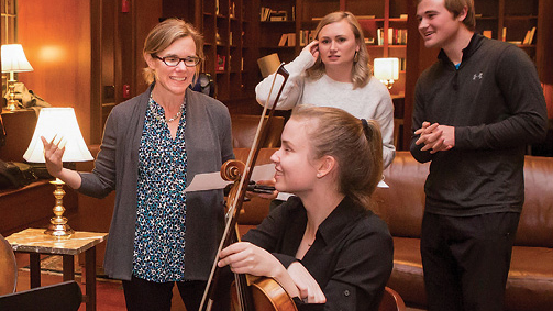Igo (left) chats with students from the Blair School of Music performing at Bronson. The event, called the Blair Salon, was organized by senior resident adviser James Dohm (right).