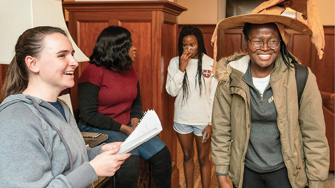 As guests try on the Sorting Hat, Rebecca Wood (left), the senior representative on the E. Bronson Ingram College Council, announces which Hogwarts houses they’ve been assigned to.