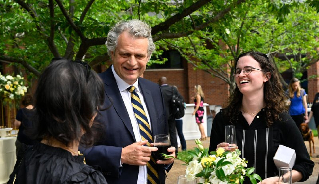 Chancellor Daniel Diermeier speaks with staff at the reception following the 2023 Spring Staff Assembly. (John Amis)