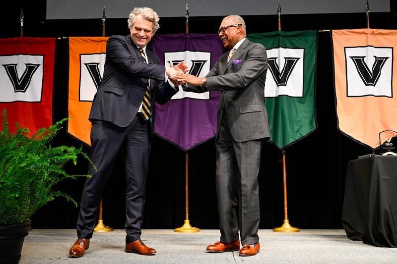 Chancellor Daniel Diermeier (left) recognizes Dr. André Churchwell during the 2023 Spring Staff Assembly. (John Amis)