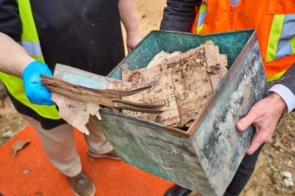 On opening Kirkland's time capsule, it was discovered that most of the contents suffered from water damage because the container was not watertight. Photos shows the decaying, brown documents.