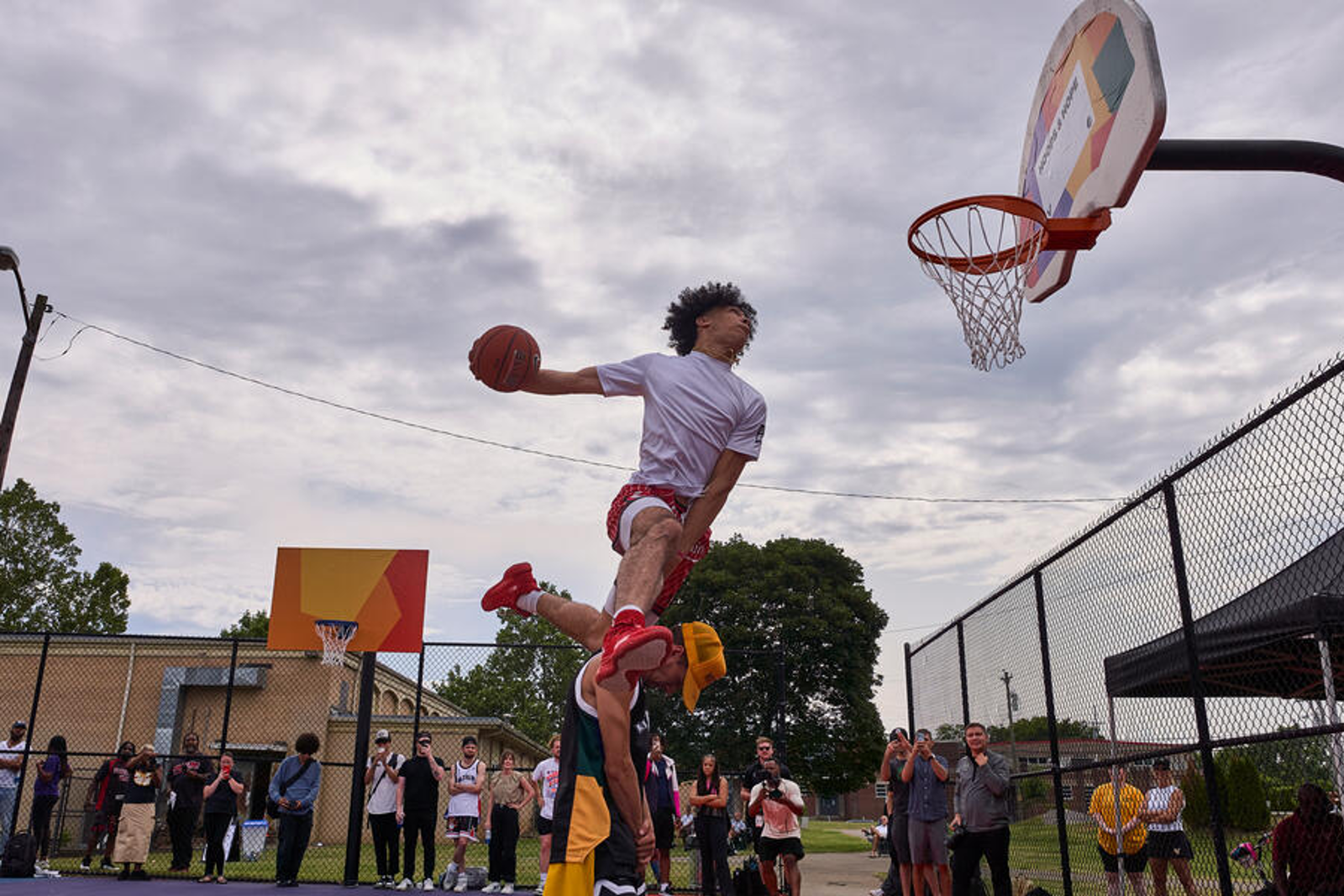 Basketball player dunking on a new goal in Watkins Park