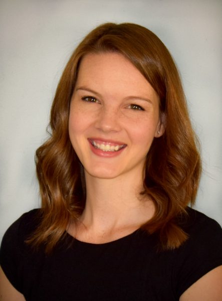 woman with long brown hair in black blouse