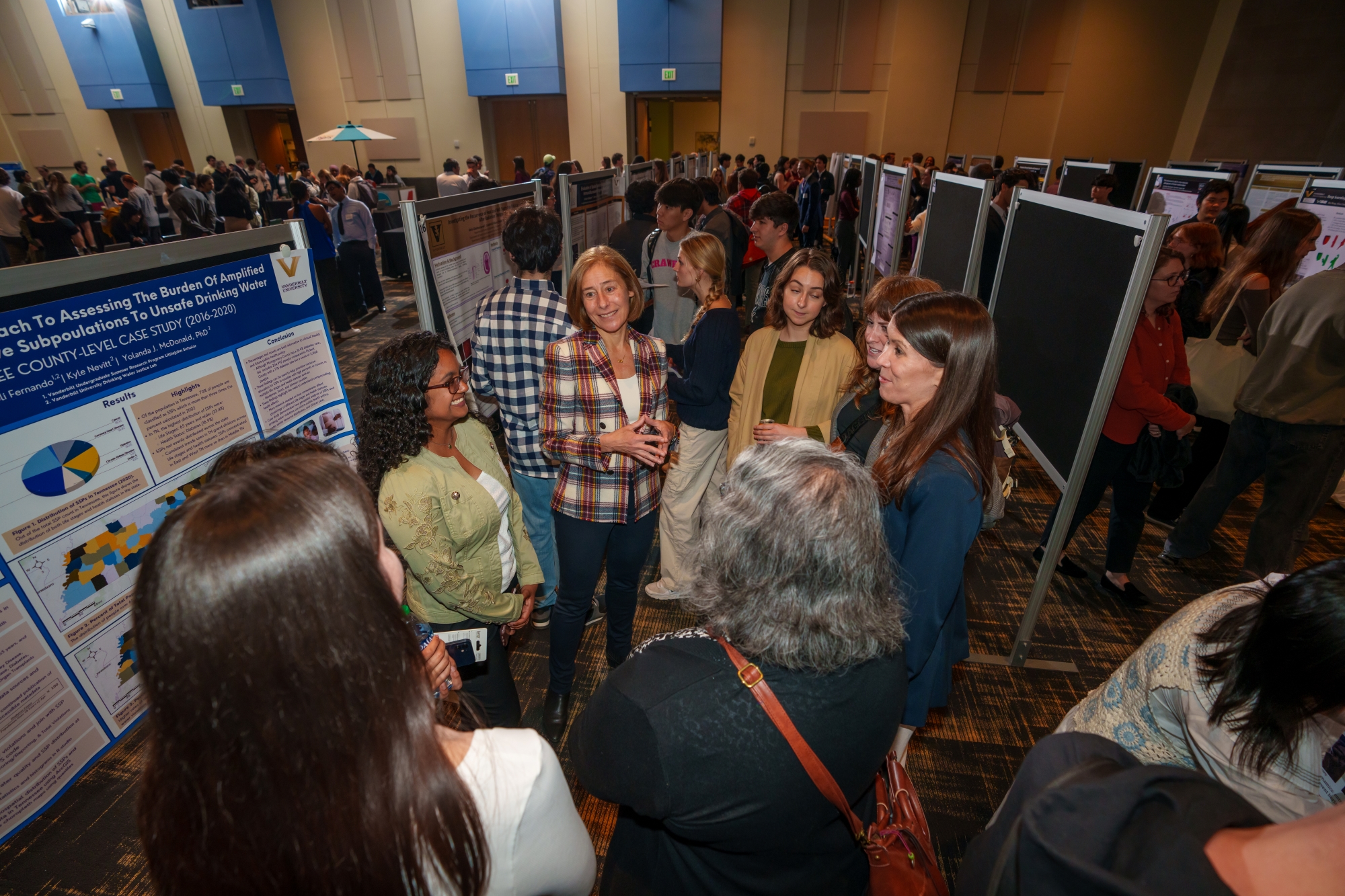 Provost C. Cybele Raver speaks with undergraduate researchers at the Fall 2023 Undergraduate Research Fair