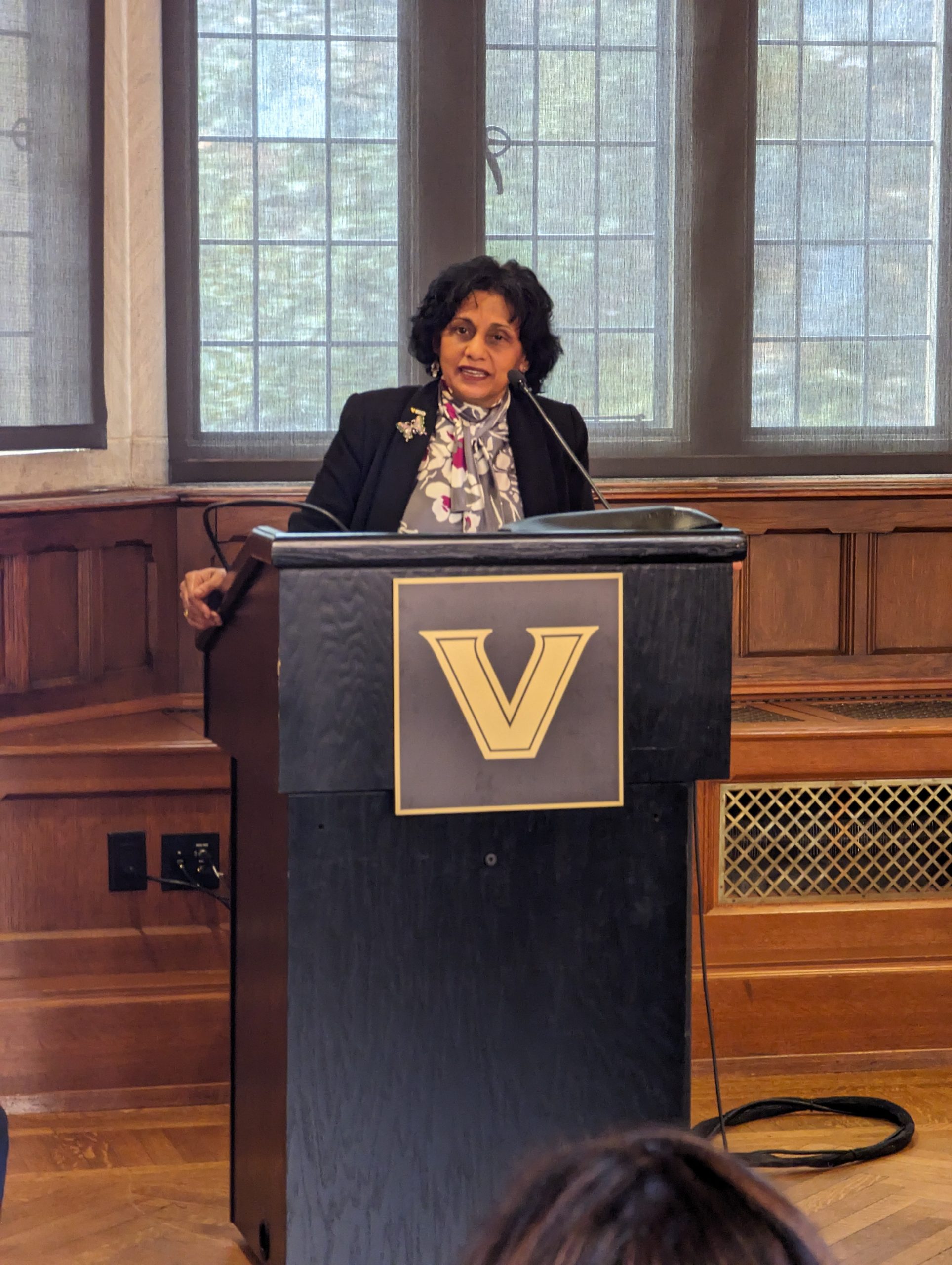 Vice Provost at a Podium during the M-TRAIN symposium