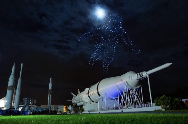 The outline of an astronaut in the night sky is made by drones.