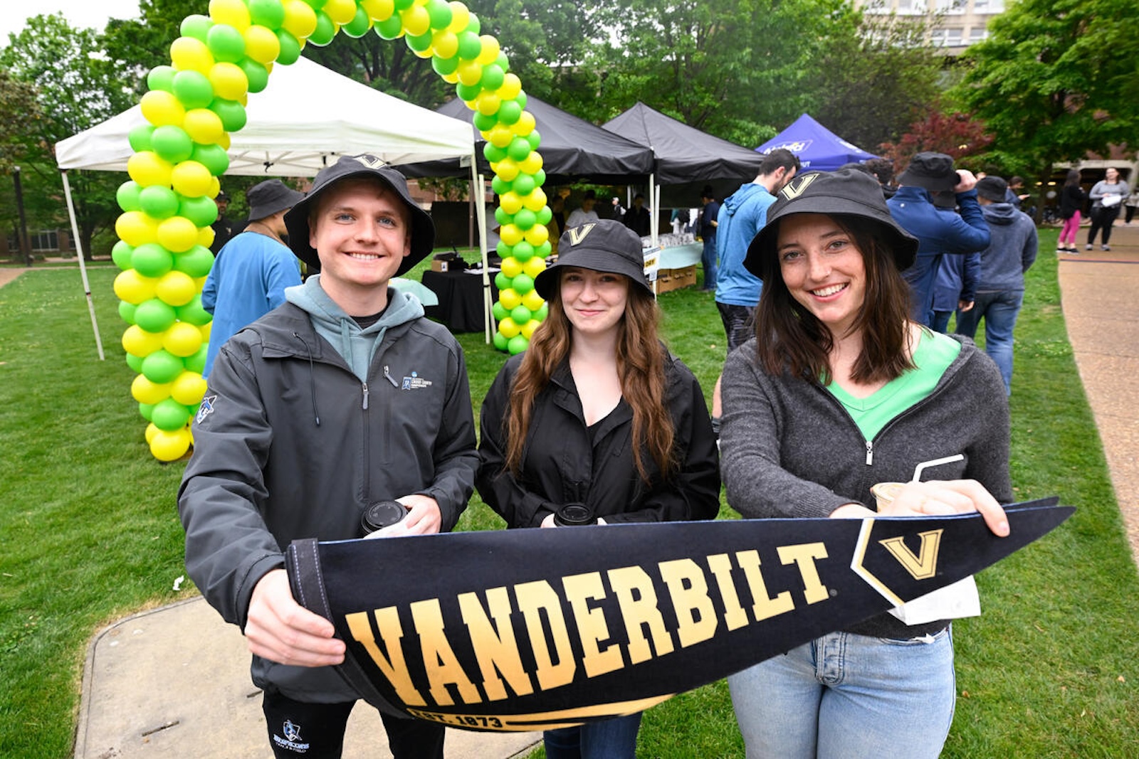 Students hold a Vanderbilt pennant at the 2023 Giving Day celebration. 
