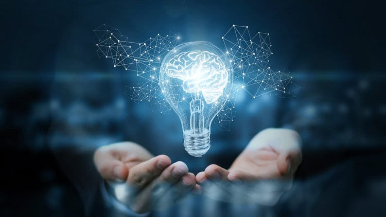 A pair of hands hold a floating lightbulb with a brain as the light, representing innovation. 