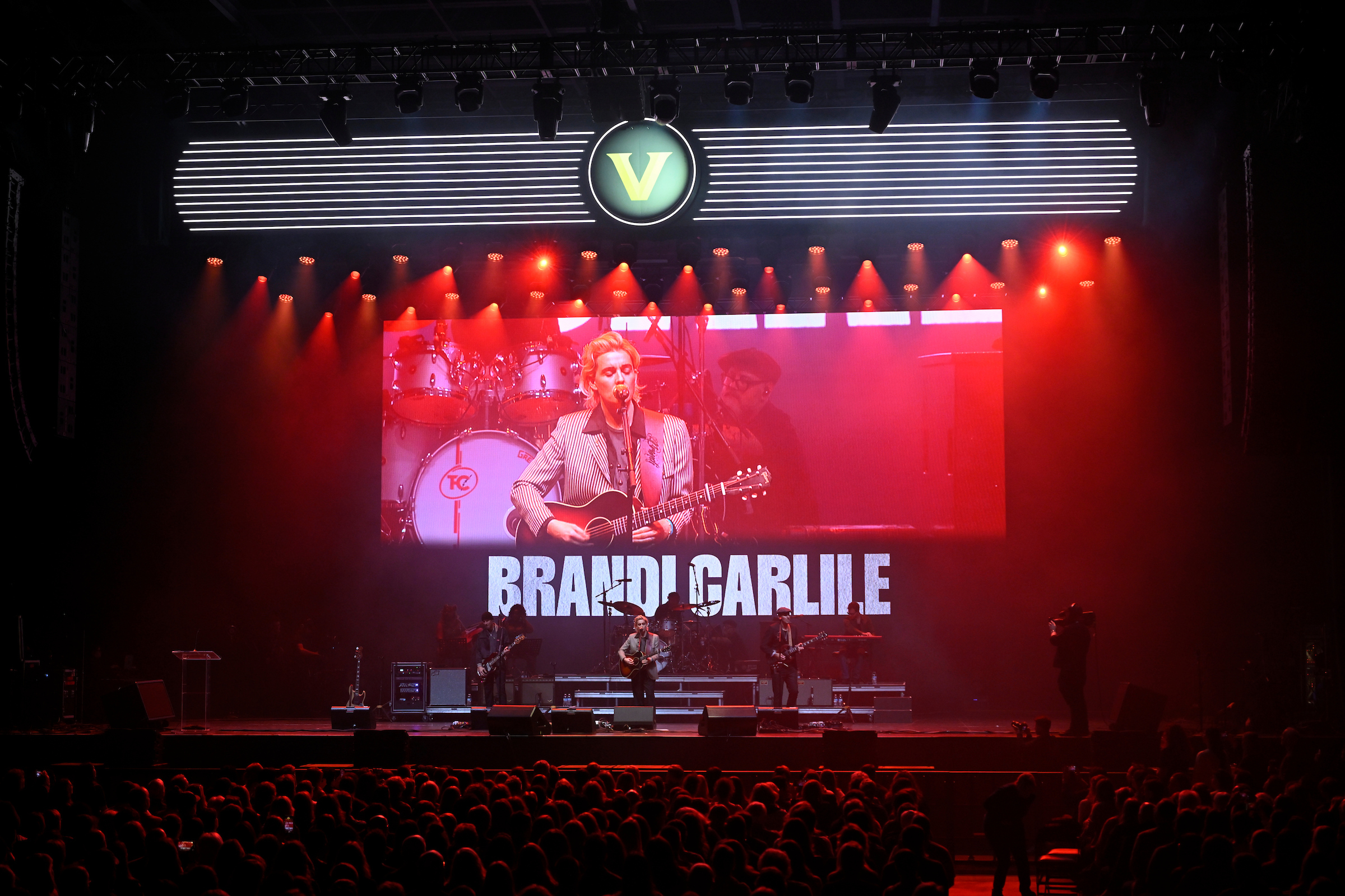 Brandi Carlili on stage with a video feed in the background