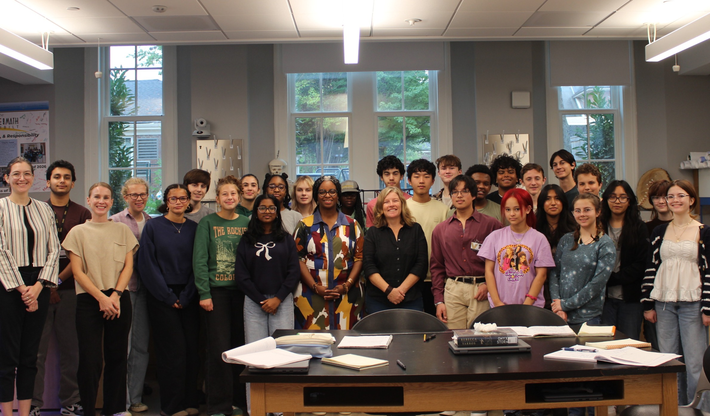 Group of students, faculty and MNPS board members pose inside a classroom.