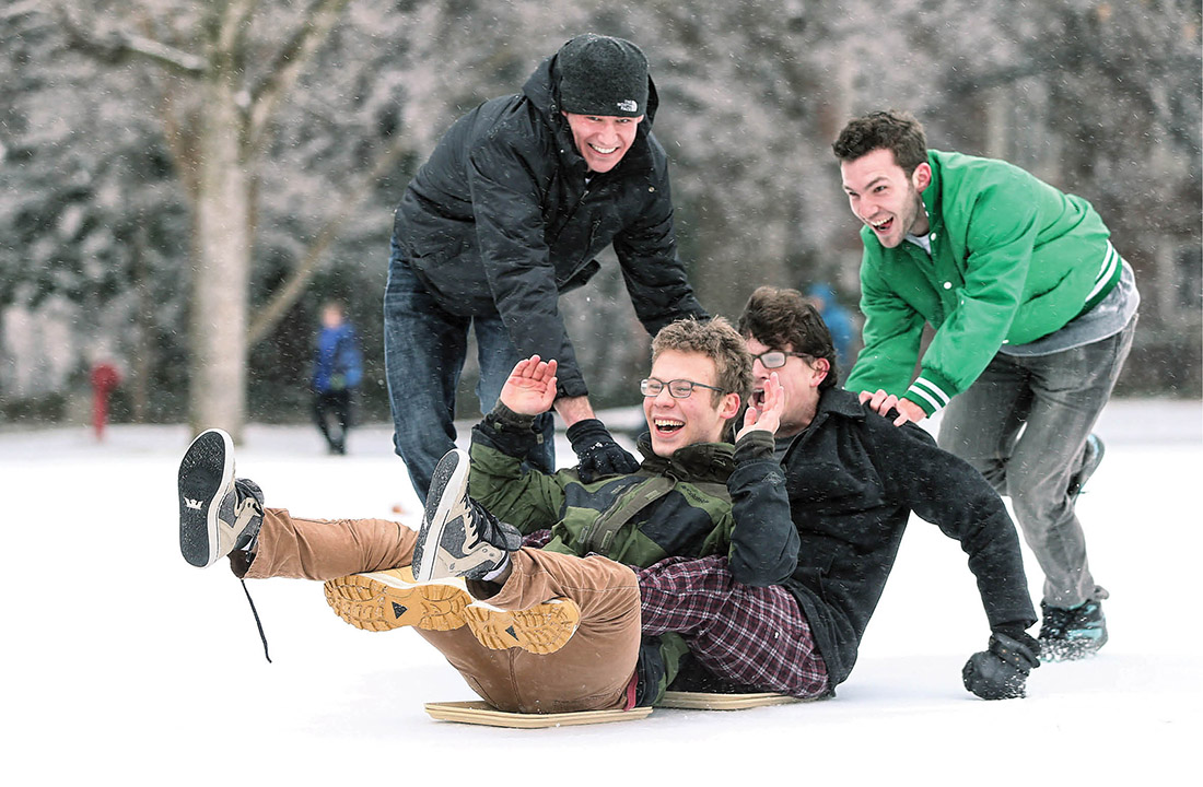 photo of students sledding on lunch trays