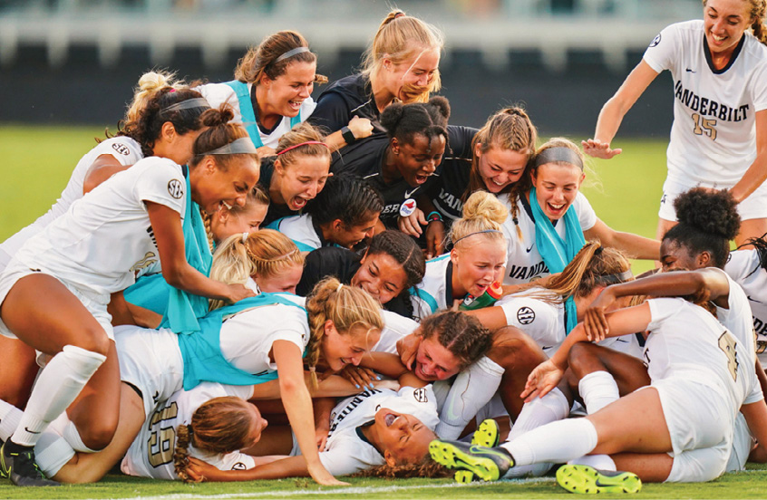 photo of soccer players celebrating in a dogpile